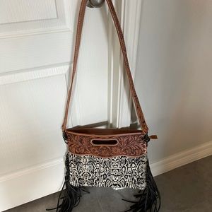 Cowhide with fringe crossbody with tooled strap
